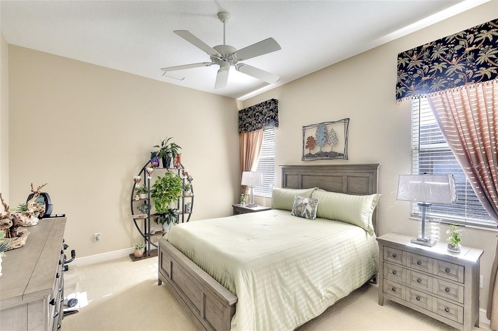 11809 Oak Ridge Drive Parrish, FL 34219 - Photo 22 of 39 a bedroom with a bed and a chandelier
