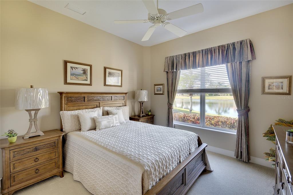 11809 Oak Ridge Drive Parrish, FL 34219 - Photo 24 of 39 a bedroom with a large bed and a window