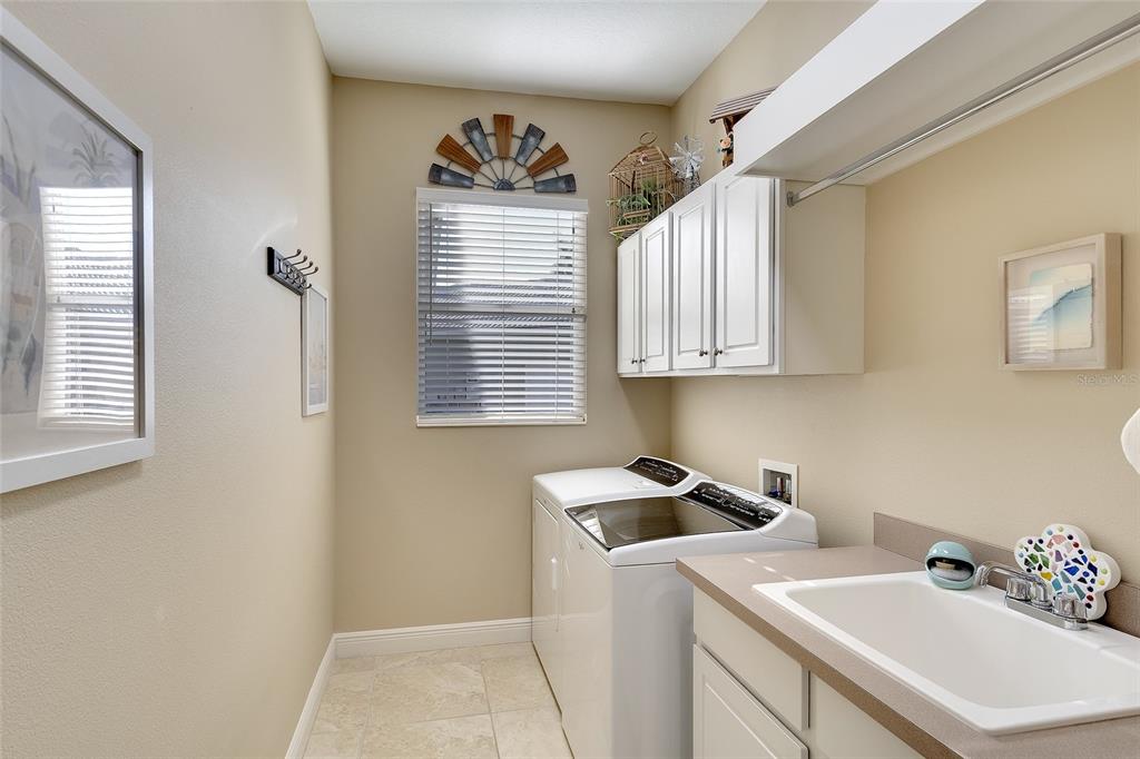 11809 Oak Ridge Drive Parrish, FL 34219 - Photo 27 of 39 a utility room with cabinets washer and dryer
