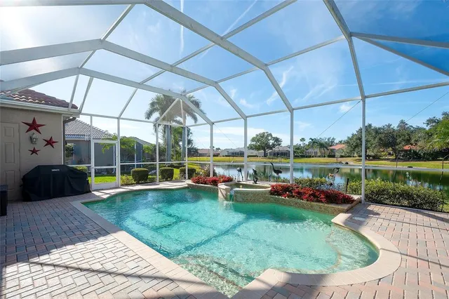 a view of a swimming pool with a patio and a yard