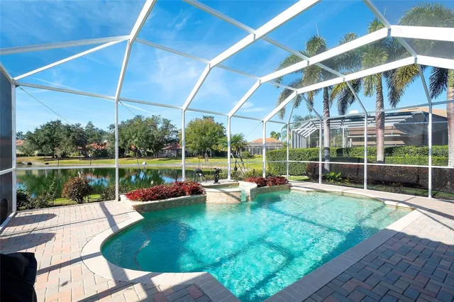 a view of a house with pool and chairs in front of it