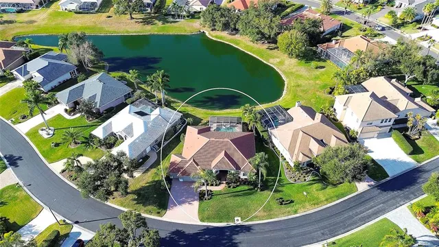 an aerial view of residential house with outdoor space and swimming pool