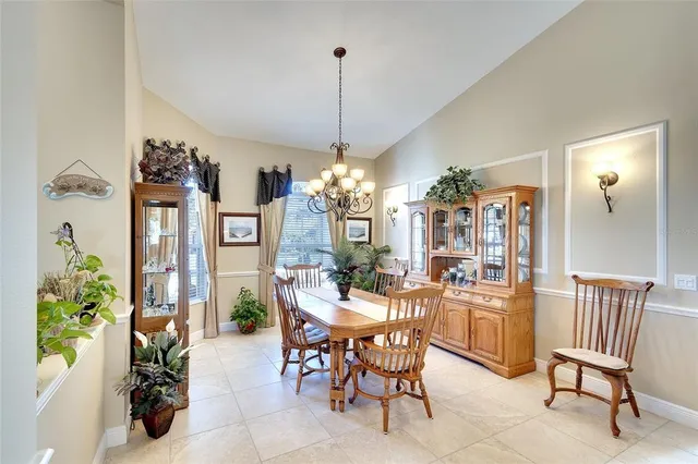 a view of a dining room with furniture and chandelier