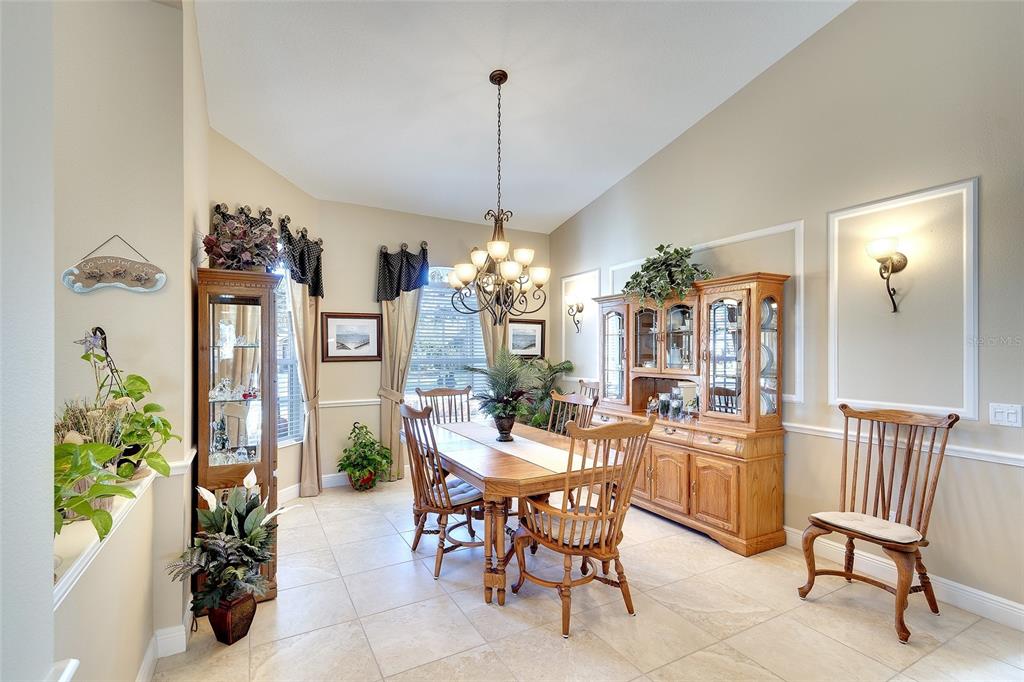 11809 Oak Ridge Drive Parrish, FL 34219 - Photo 7 of 39 a view of a dining room with furniture and chandelier