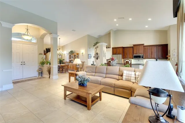 a living room with furniture and kitchen view
