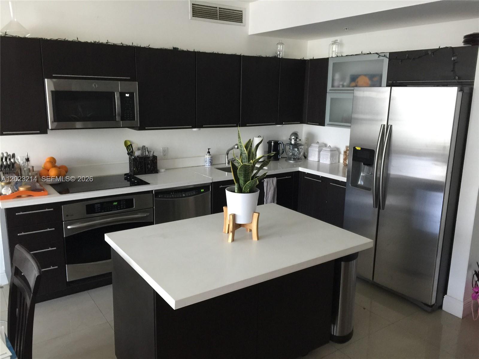90 Southwest 3rd Street, Unit 2614 Miami, FL 33130 - Photo 11 of 13 a kitchen with a refrigerator and a sink