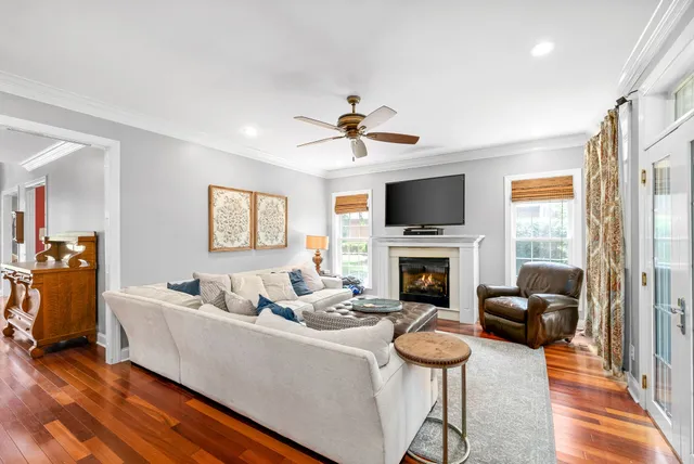 a kitchen with stainless steel appliances a dining table chairs refrigerator and sink