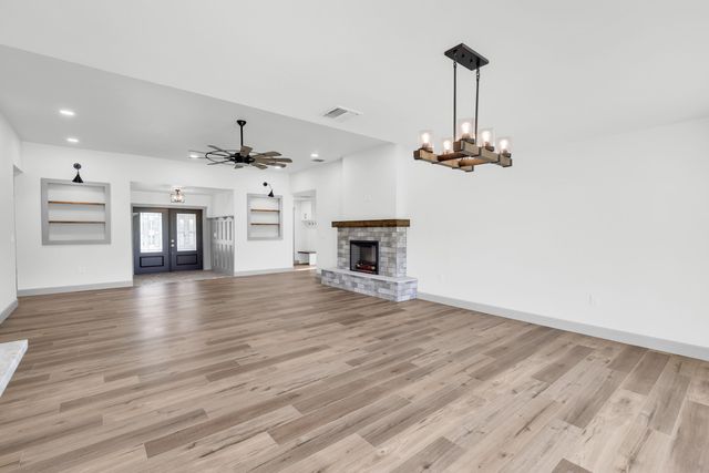 a large kitchen with kitchen island a white cabinets and stainless steel appliances