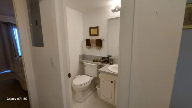 a white toilet sitting next to a bathroom sink