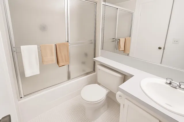 a white toilet sitting next to a bathroom sink