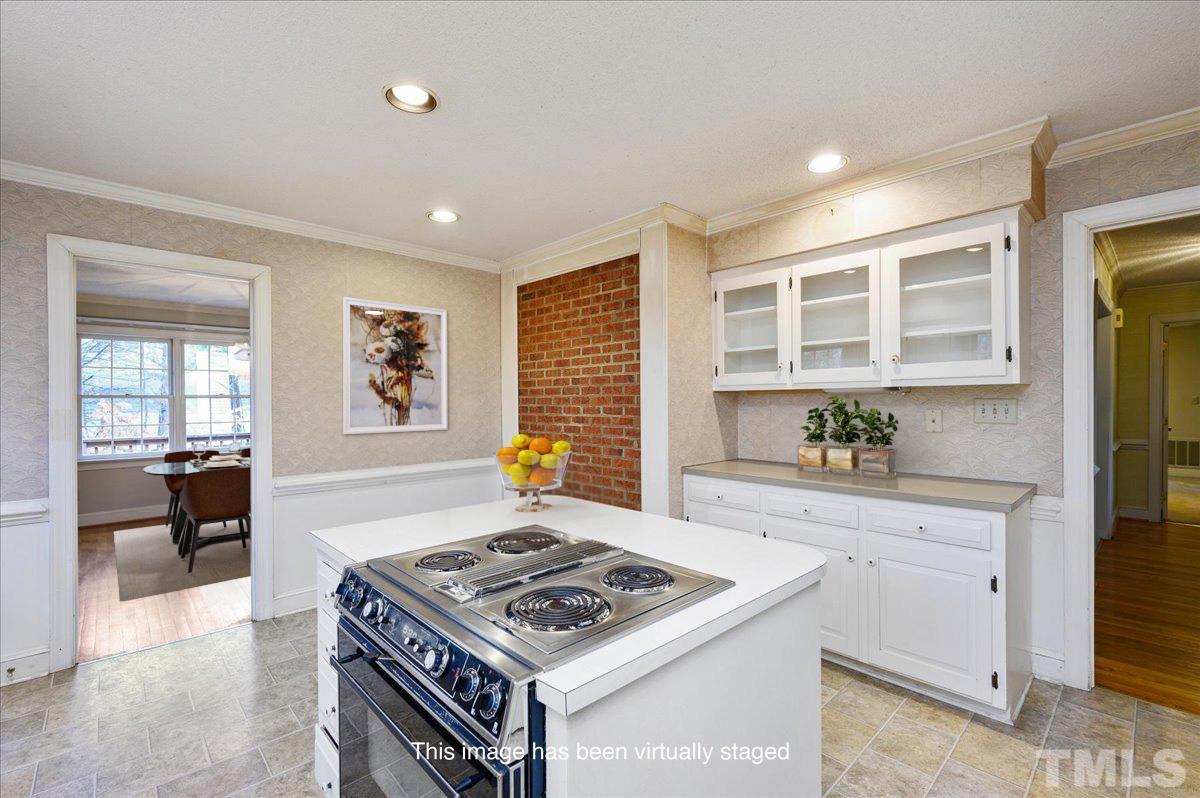 4112 Landfall Court Raleigh, NC 27613 - Photo 16 of 27 a kitchen with a stove and a sink