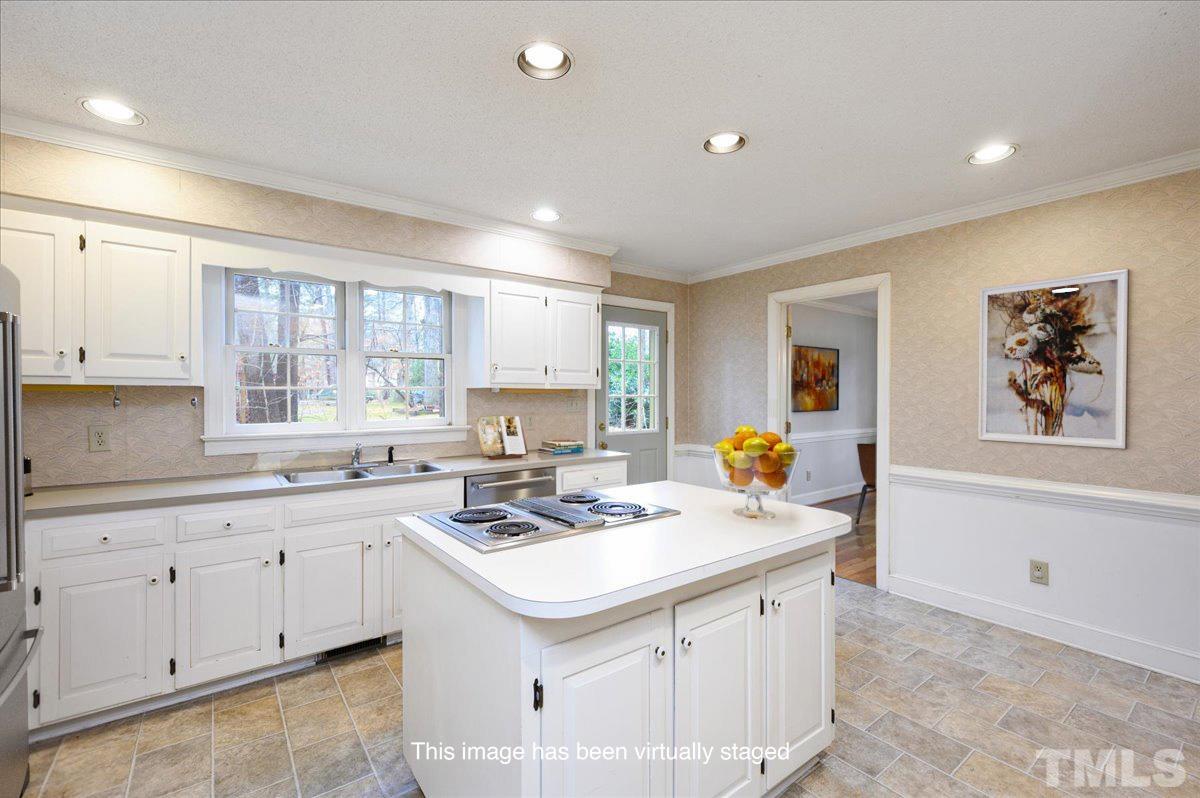 4112 Landfall Court Raleigh, NC 27613 - Photo 17 of 27 a kitchen that has a sink a stove and cabinets