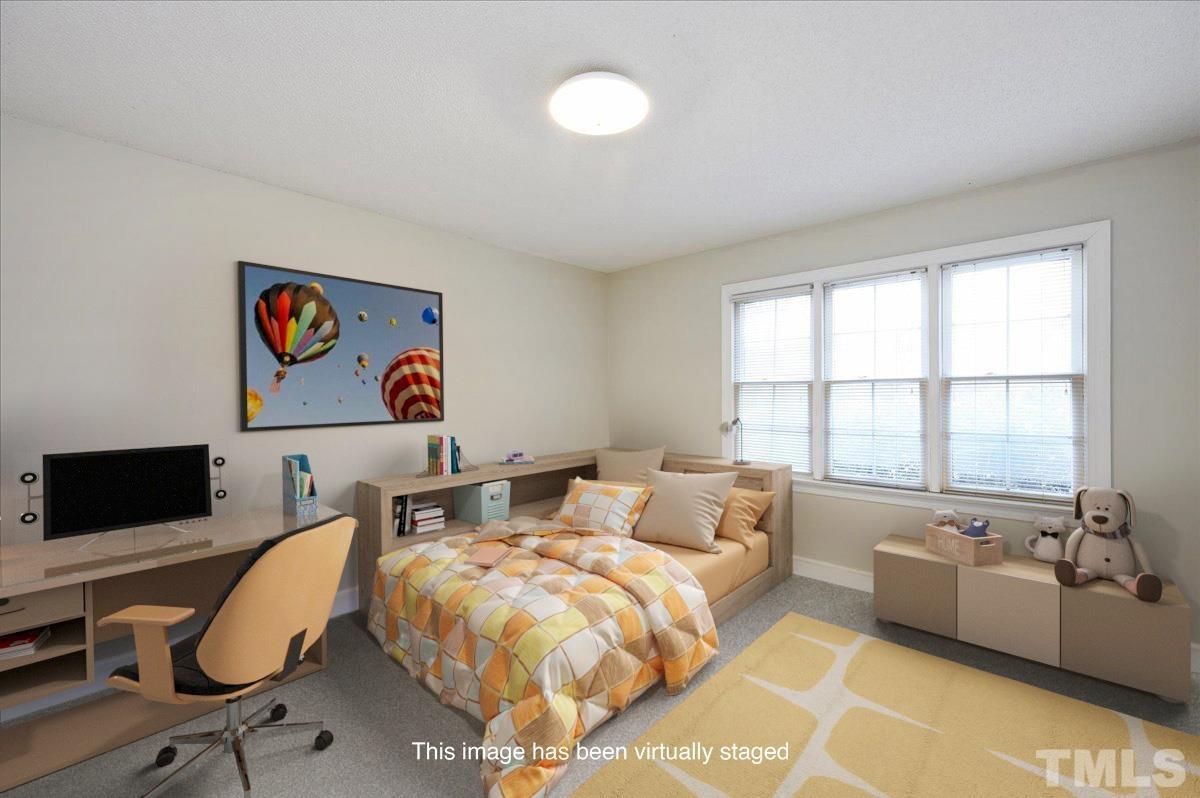 4112 Landfall Court Raleigh, NC 27613 - Photo 20 of 27 a living room with furniture and a flat screen tv