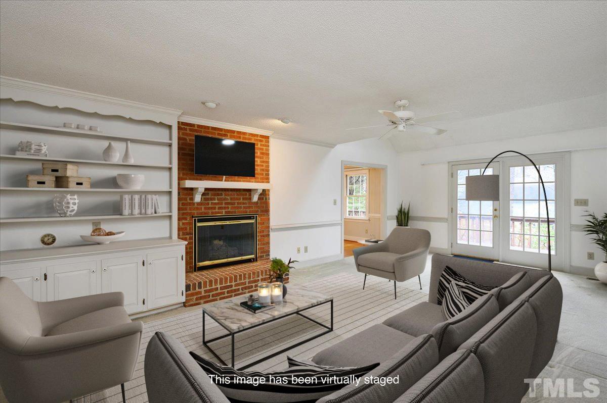 4112 Landfall Court Raleigh, NC 27613 - Photo 2 of 27 a living room with furniture and a flat screen tv