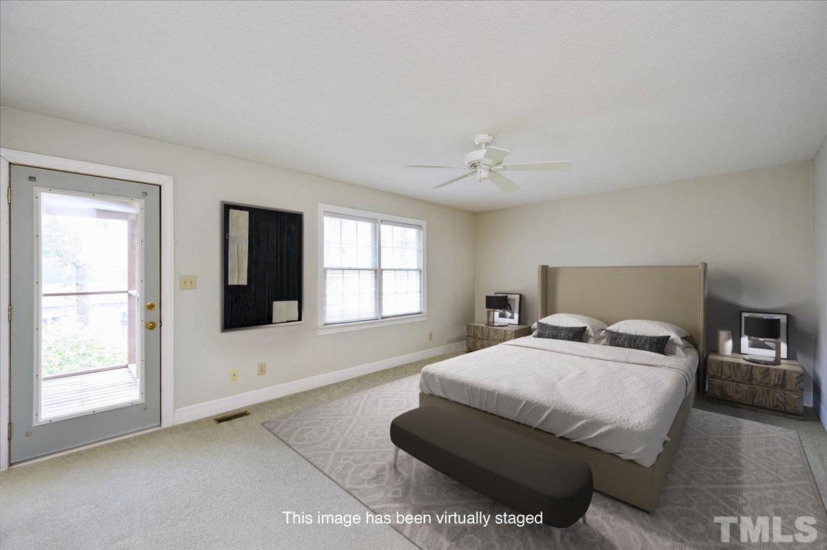 4112 Landfall Court Raleigh, NC 27613 - Photo 21 of 27 a bedroom with a bed and a large window