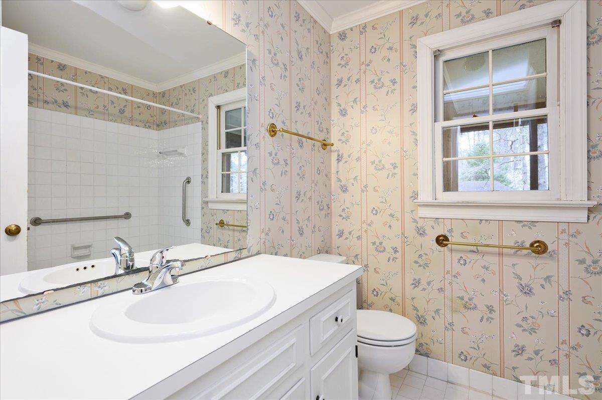4112 Landfall Court Raleigh, NC 27613 - Photo 24 of 27 a bathroom with a sink a toilet and shower