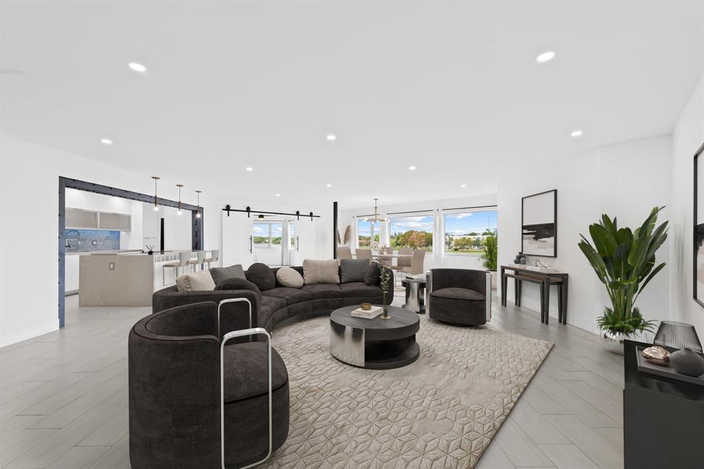 877 Northeast 195th Street, Unit 422 Miami, FL 33179 - Photo 1 of 23 a living room with furniture potted plant and kitchen view