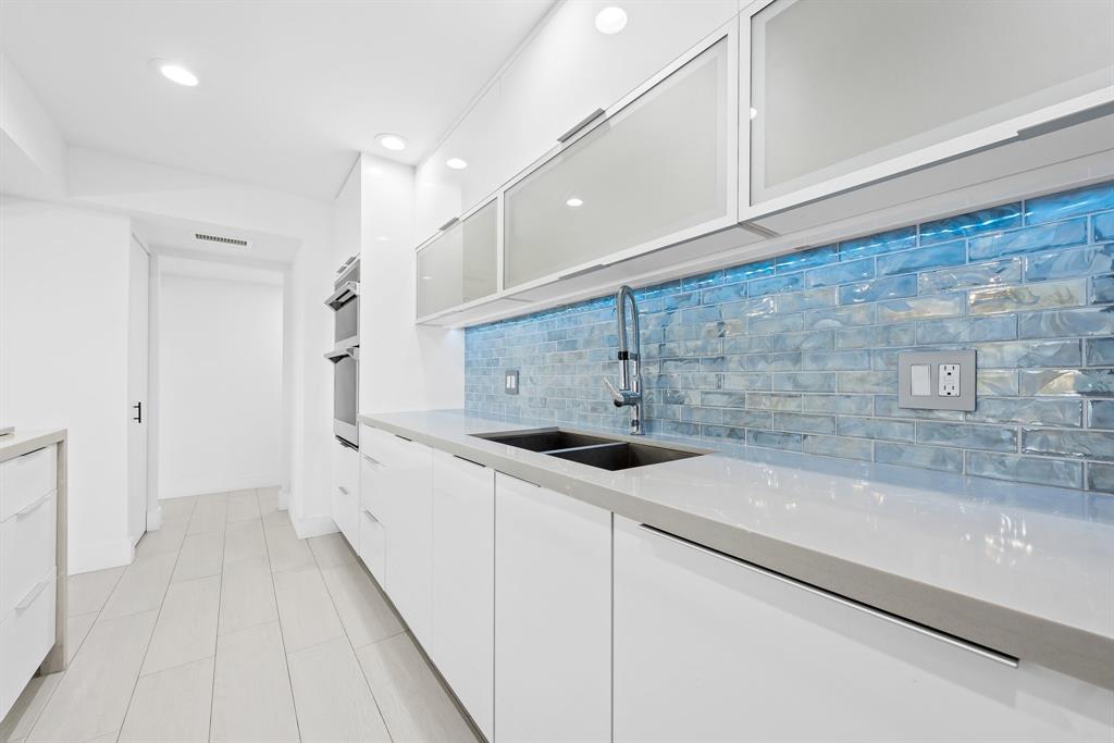 877 Northeast 195th Street, Unit 422 Miami, FL 33179 - Photo 11 of 23 a kitchen with a sink and cabinets