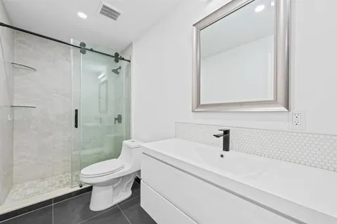 a white toilet sitting next to a bath tub