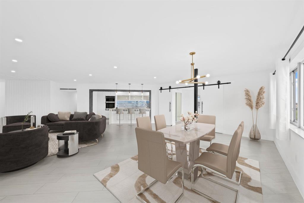 877 Northeast 195th Street, Unit 422 Miami, FL 33179 - Photo 2 of 23 a view of a dining room with furniture