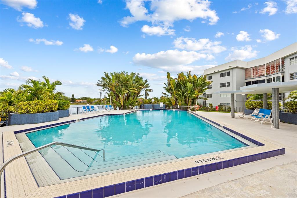 877 Northeast 195th Street, Unit 422 Miami, FL 33179 - Photo 22 of 23 a view of a swimming pool with a lounge chairs