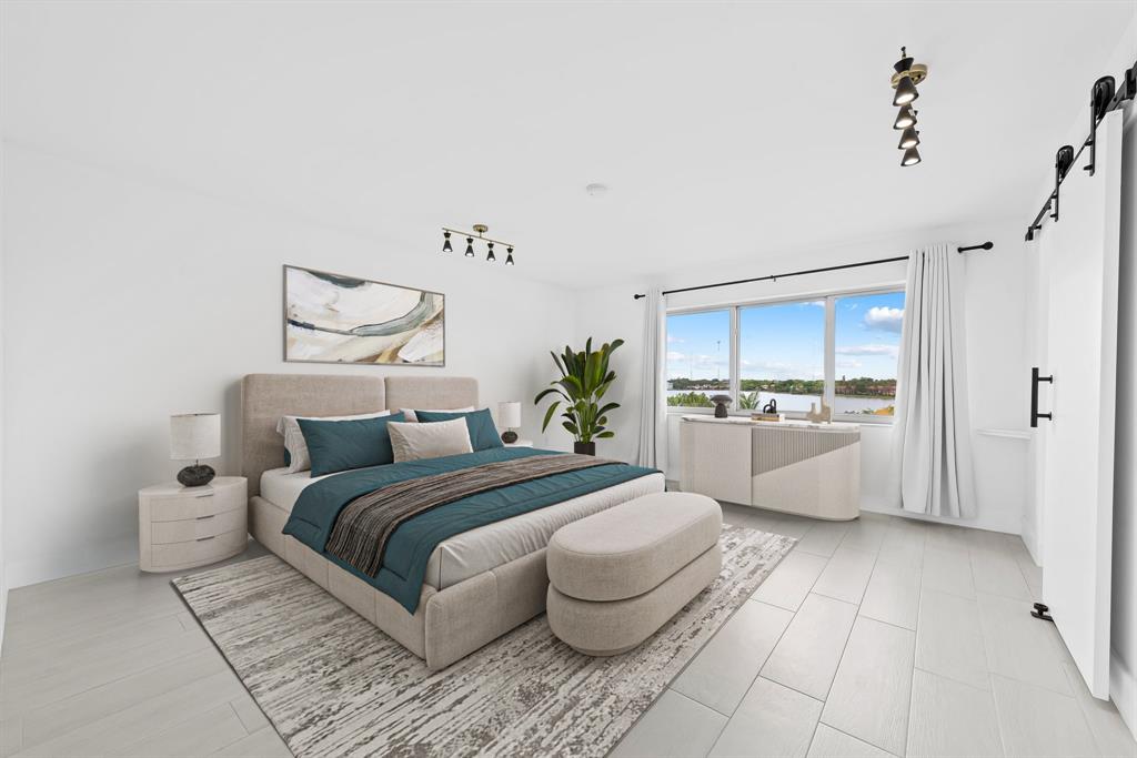 877 Northeast 195th Street, Unit 422 Miami, FL 33179 - Photo 6 of 23 a bedroom with a large bed and a view of kitchen