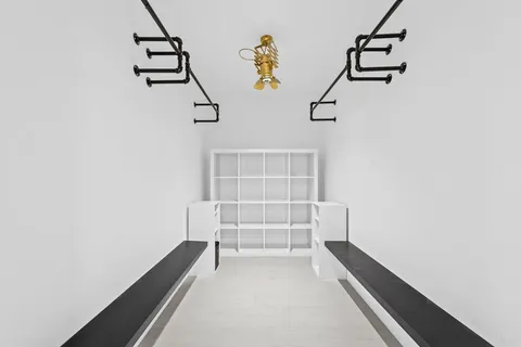 a view of hallway with stairs and chandelier