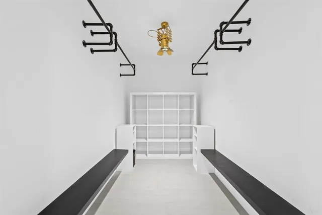 a view of hallway with stairs and chandelier