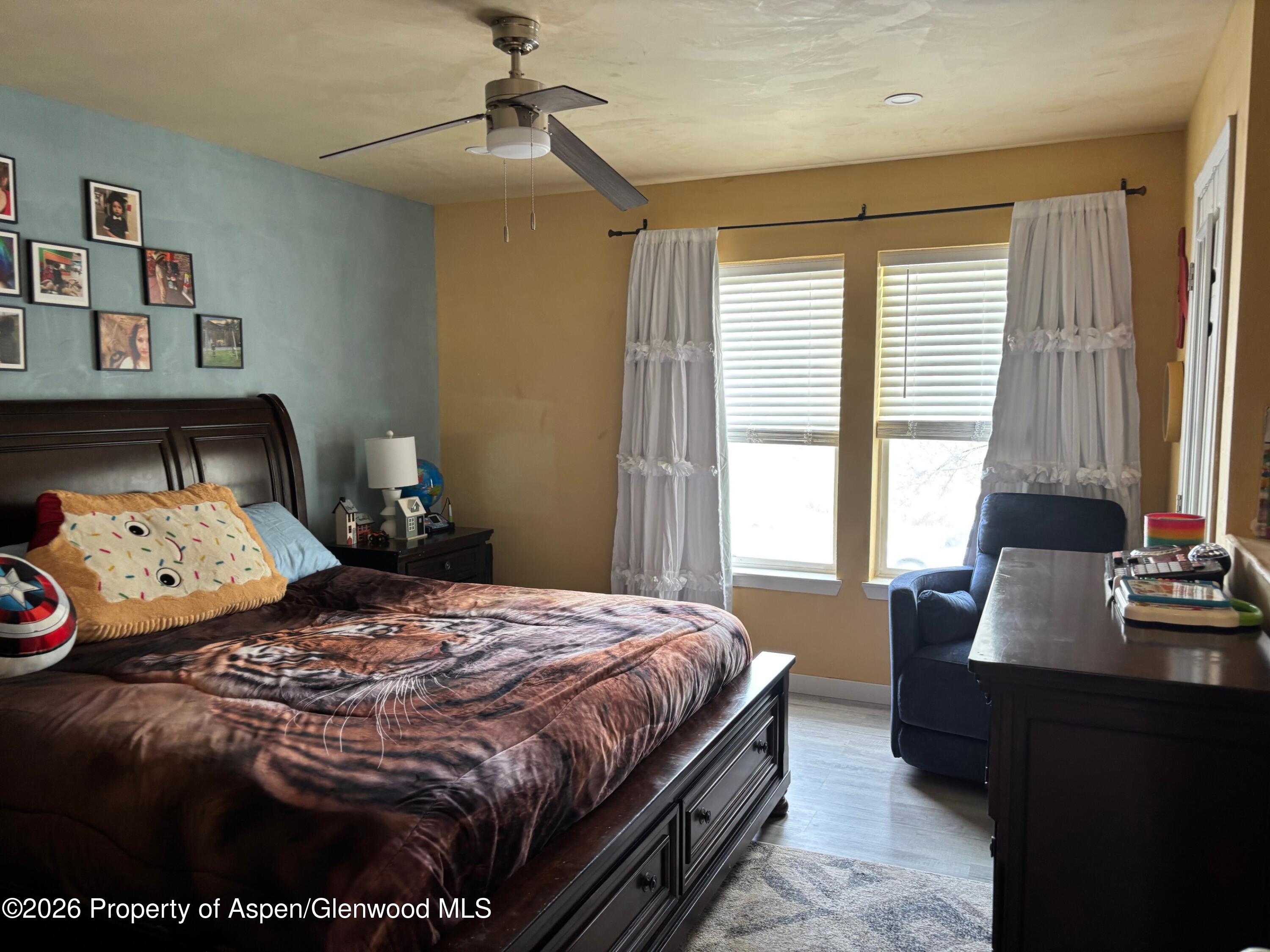 2603 Acacia Avenue Rifle, CO 81650 - Photo 11 of 29 a bedroom with a bed and wooden floor