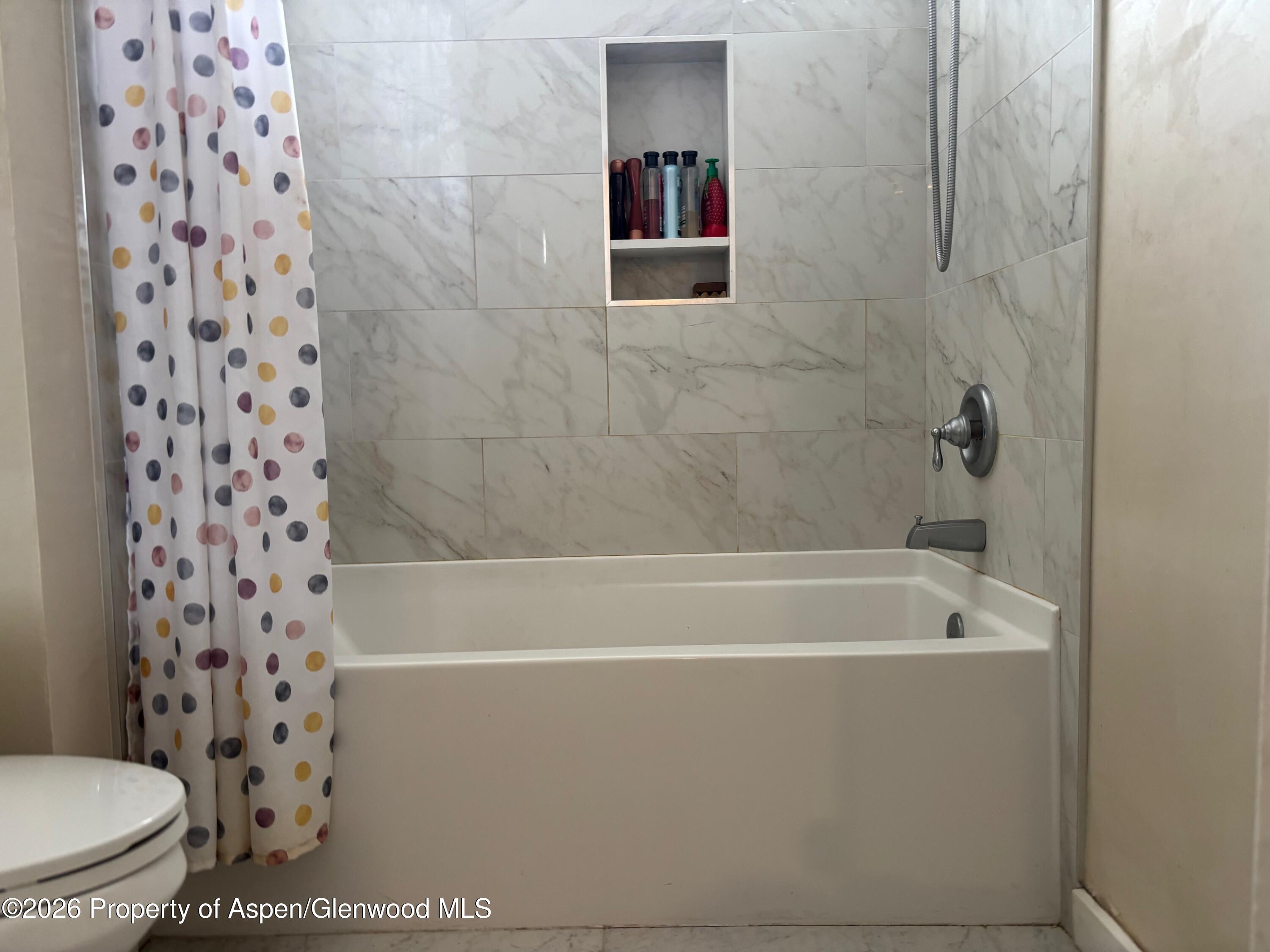 2603 Acacia Avenue Rifle, CO 81650 - Photo 13 of 29 a bathroom with a shower and a toilet