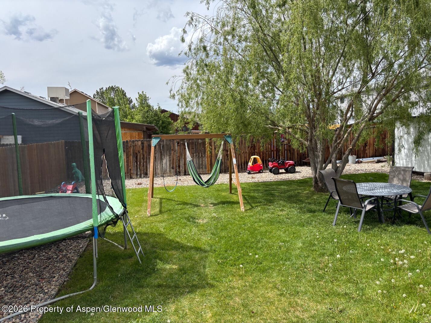 2603 Acacia Avenue Rifle, CO 81650 - Photo 25 of 29 a garden with trees and wooden fence