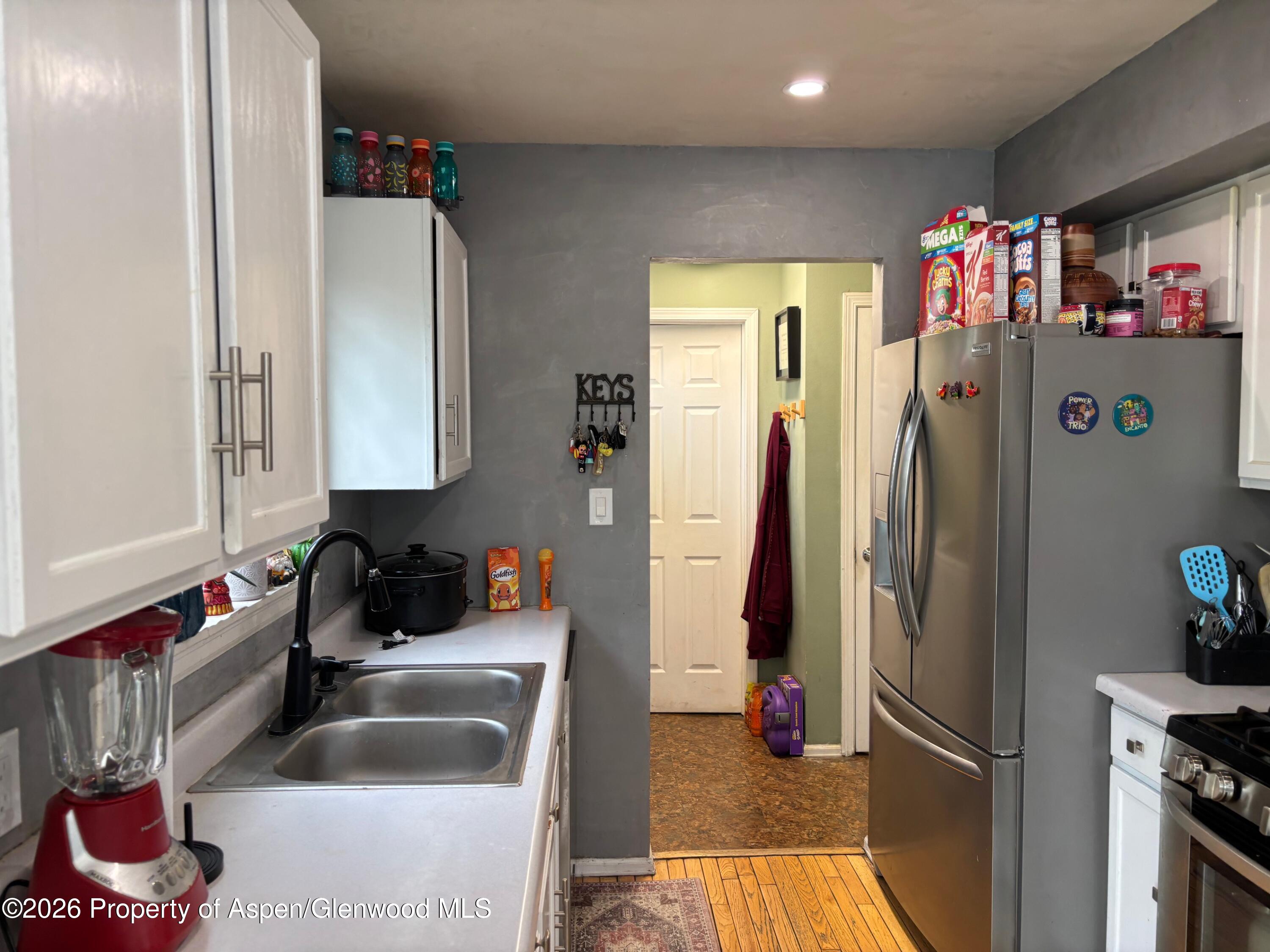 2603 Acacia Avenue Rifle, CO 81650 - Photo 3 of 29 a kitchen with refrigerator and cabinets