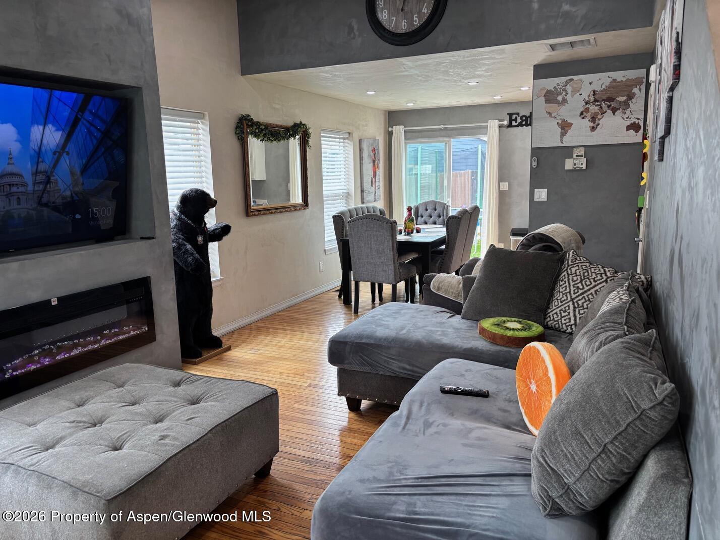 2603 Acacia Avenue Rifle, CO 81650 - Photo 7 of 29 a living room with furniture a flat screen tv and a fireplace