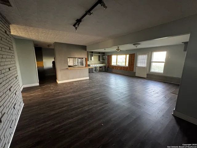 a view of a living room and kitchen with furniture
