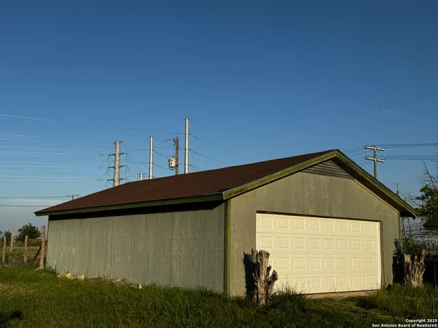 a front view of house along with trees