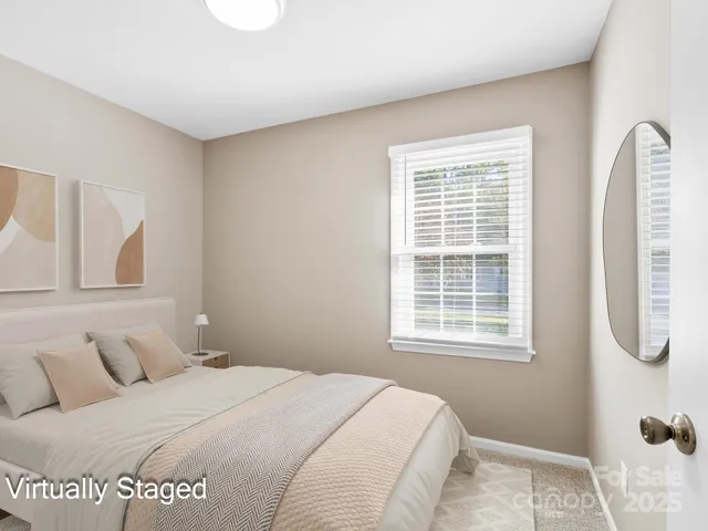 a bedroom with a bed a dresser and a window