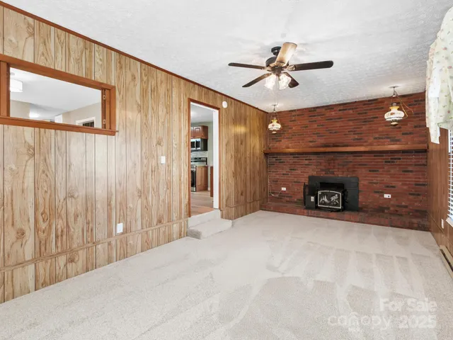 a view of a livingroom with a ceiling fan and window