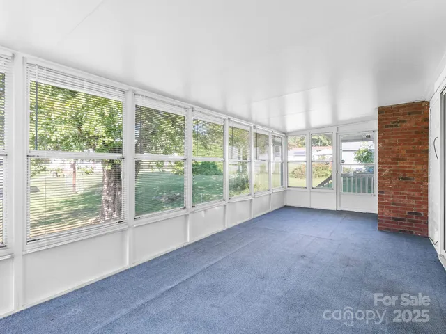 a view of room with balcony and mountain view