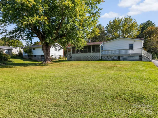 a house view with swimming pool in front of it