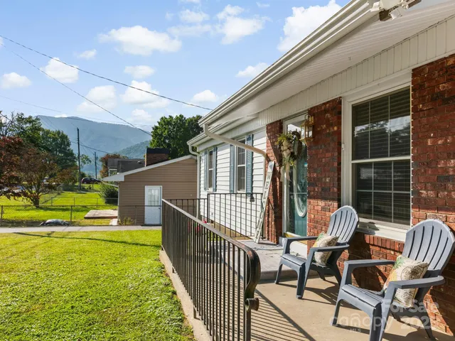 a view of a chair and tables in the balcony
