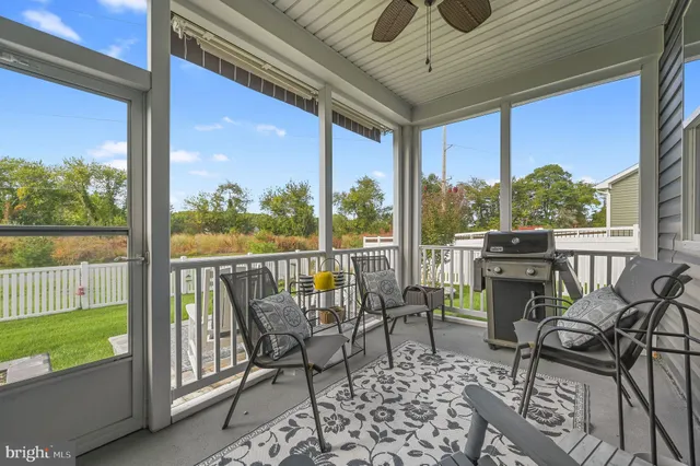 a view of a chairs and table in patio with a yard