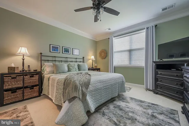 a bedroom with a bed and a television