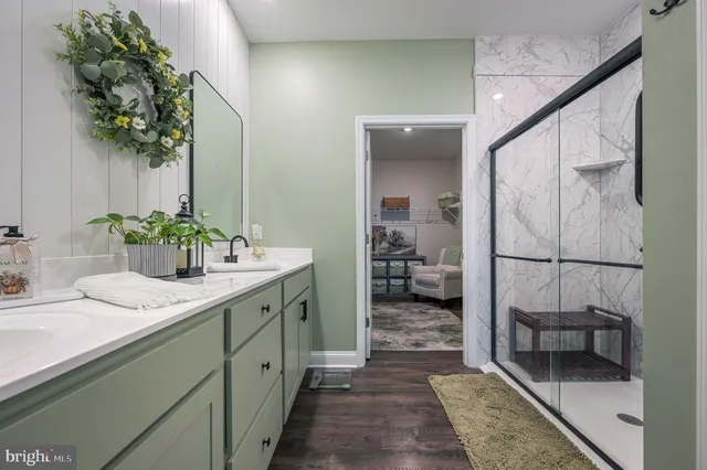 a hallway with sink and mirror