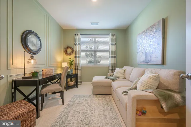 a living room with furniture and a mirror