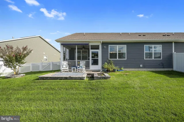 a view of a house with backyard sitting area and garden