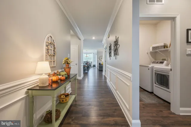 a hallway with white furniture a washer and dryer