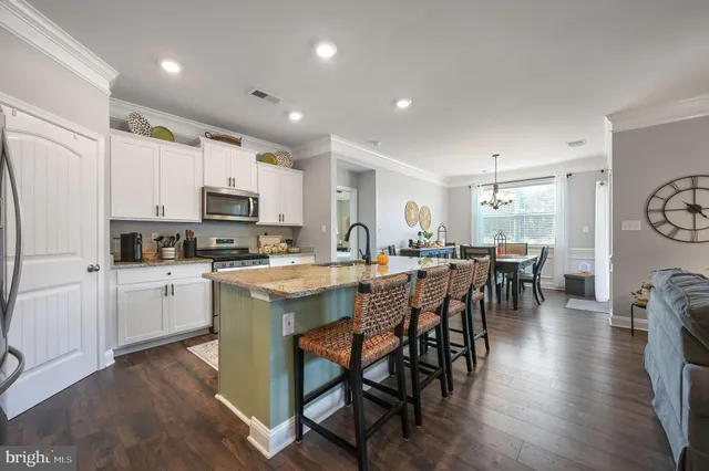 a kitchen with appliances a sink a counter top space and cabinets