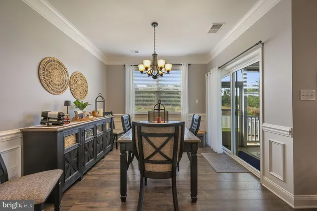 a dining room with furniture window and wooden floor