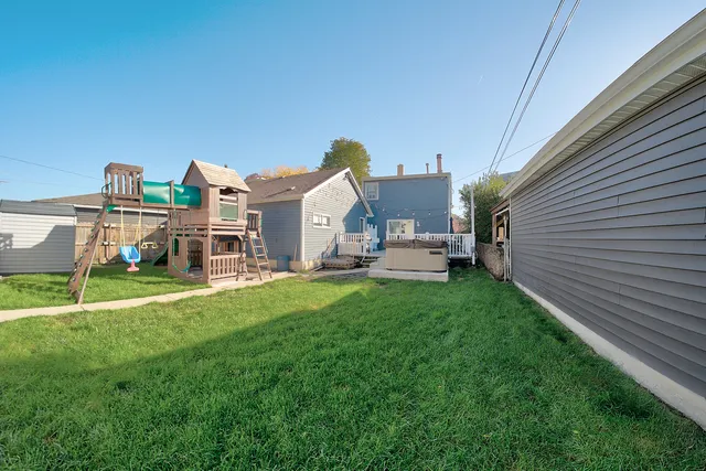 a view of a house with a backyard