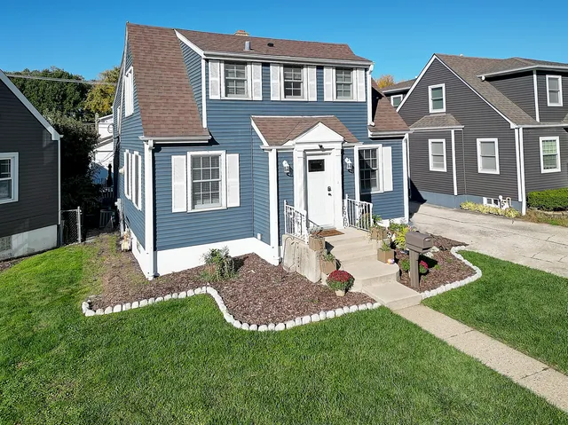 a front view of a house with a yard and patio